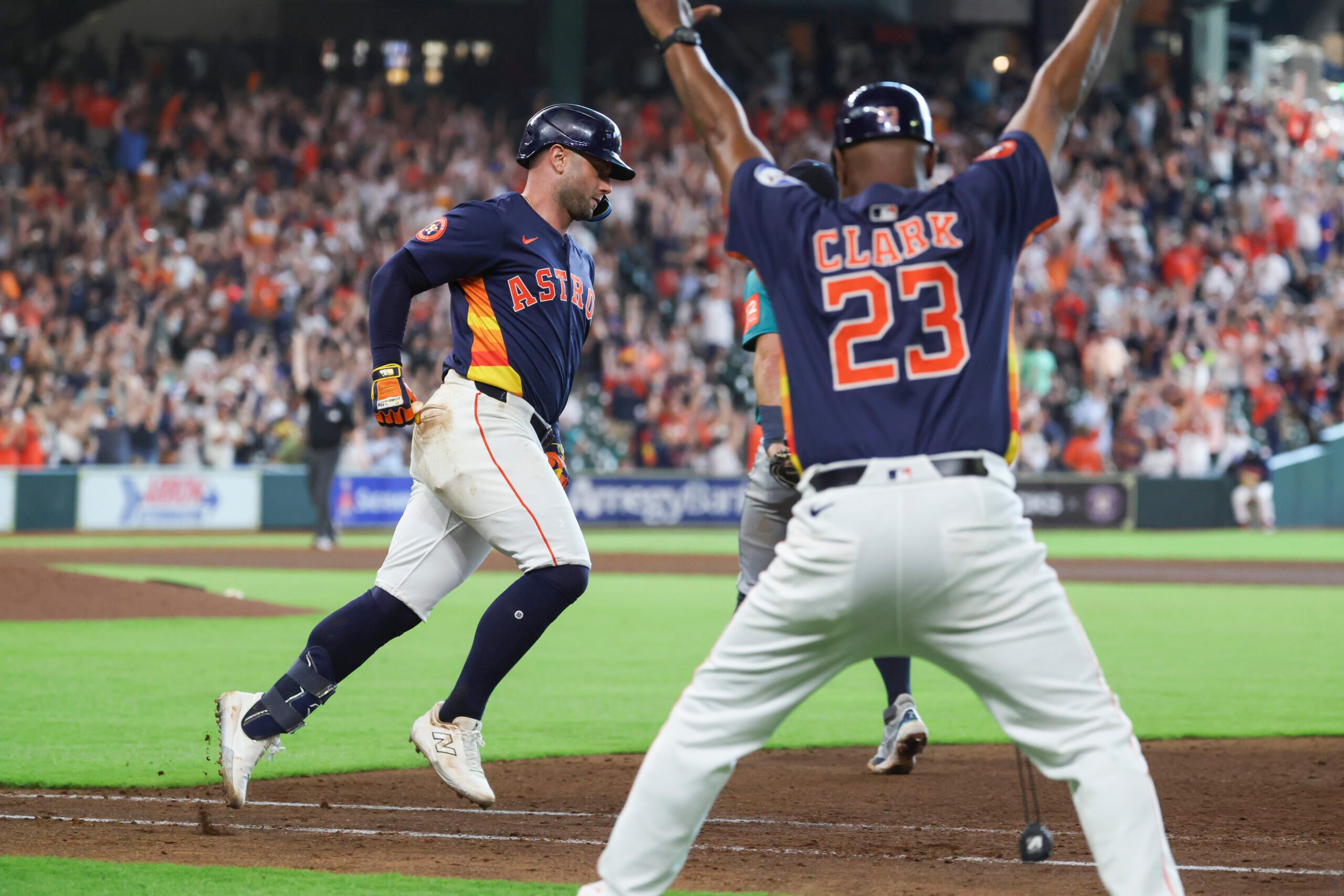 May 25, 2025; Houston, Texas, USA; Houston Astros first base coach Dave Clark (23) reacts and first baseman Christian Walker (8) rounds the bases after hitting a walk-off home run during the ninth inning against the Seattle Mariners at Daikin Park. Mandatory Credit: Troy Taormina-Imagn Images