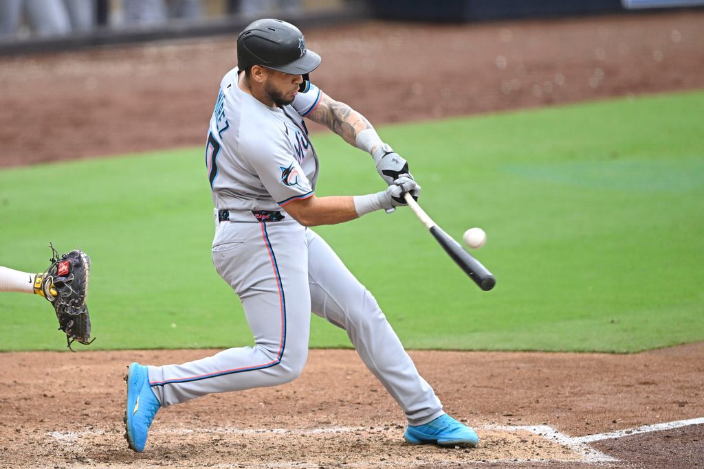 May 28, 2025; San Diego, California, USA; Miami Marlins catcher Agustin Ramirez (50) hits a single during the seventh inning against the San Diego Padres at Petco Park. Mandatory Credit: Denis Poroy-Imagn Images
