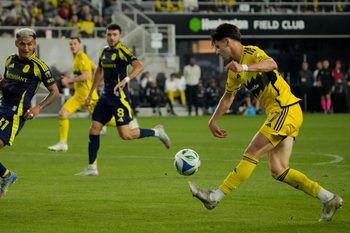 Columbus Crew forward Max Arfsten (27) crosses the ball against Nashville SC midfielder Andy Najar (31) in the second half during their MLS game at Lower.com Field on May 28, 2025.