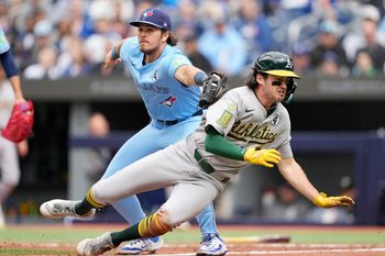 Jun 1, 2025; Toronto, Ontario, CAN; Toronto Blue Jays third baseman Addison Barger (47) tags Oakland Athletics shortstop Jacob Wilson (5) in a run down at home plate during the fifth inning at Rogers Centre. Mandatory Credit: John E. Sokolowski-Imagn Images