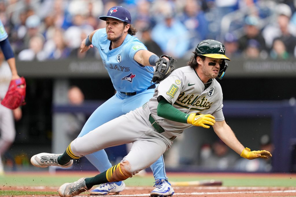 Jun 1, 2025; Toronto, Ontario, CAN; Toronto Blue Jays third baseman Addison Barger (47) tags Oakland Athletics shortstop Jacob Wilson (5) in a run down at home plate during the fifth inning at Rogers Centre. Mandatory Credit: John E. Sokolowski-Imagn Images