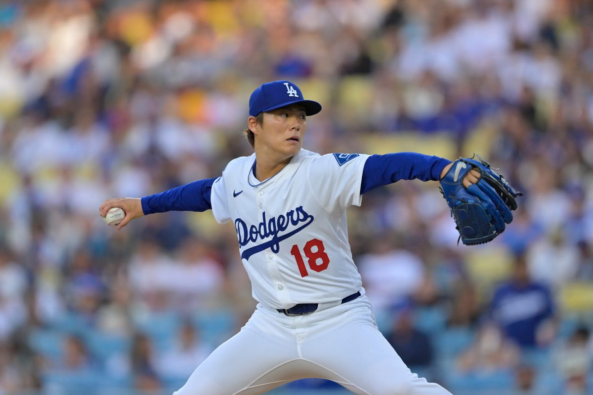 Jun 19, 2025; Los Angeles, California, USA; Los Angeles Dodgers pitcher Yoshinobu Yamamoto (18) delivers a pitch during the first inning against the San Diego Padres at Dodger Stadium. Mandatory Credit: Jayne Kamin-Oncea-Imagn Images
