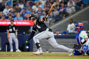 Jun 22, 2025; Toronto, Ontario, CAN; Chicago White Sox third base Miguel Vargas (20) hits a double against the Toronto Blue Jays during the eighth inning at Rogers Centre. Mandatory Credit: Kevin Sousa-Imagn Images