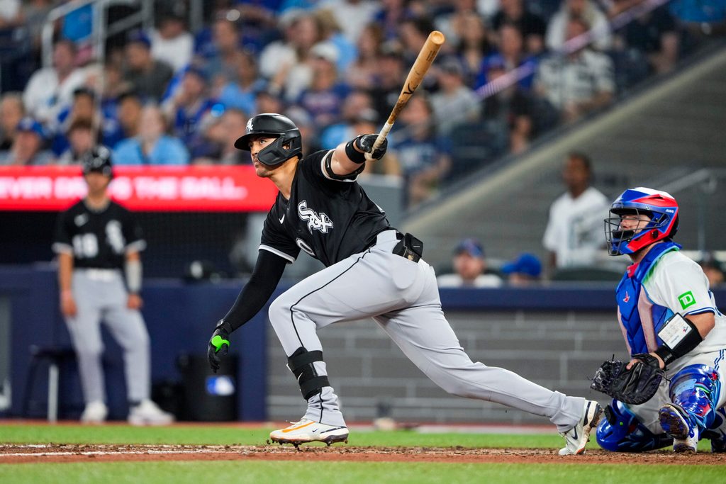 Jun 22, 2025; Toronto, Ontario, CAN; Chicago White Sox third base Miguel Vargas (20) hits a double against the Toronto Blue Jays during the eighth inning at Rogers Centre. Mandatory Credit: Kevin Sousa-Imagn Images