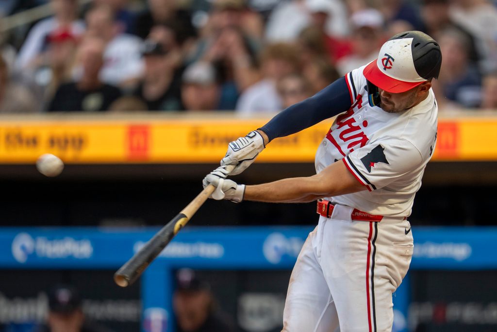 Jun 23, 2025; Minneapolis, Minnesota, USA; Minnesota Twins right fielder Trevor Larnach (9) hits a solo home run against the Seattle Mariners in the sixth inning at Target Field. Mandatory Credit: Jesse Johnson-Imagn Images