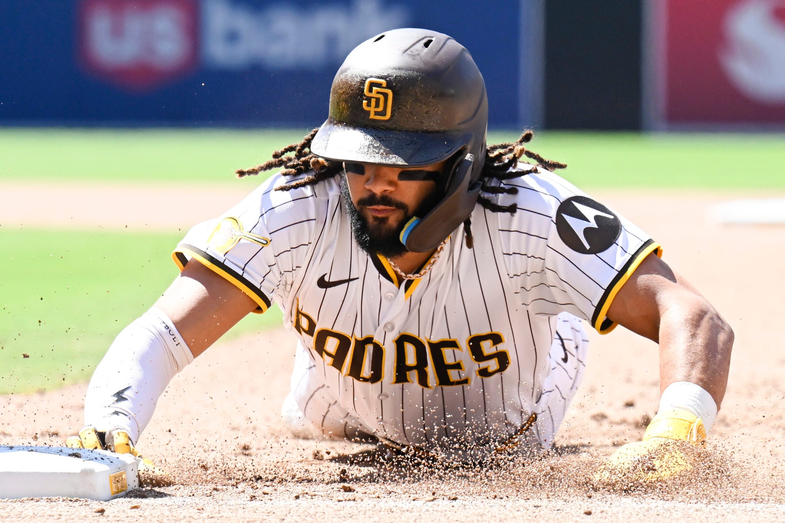 Jun 25, 2025; San Diego, California, USA; San Diego Padres right fielder Fernando Tatis Jr. (23) gets back to first base during the eighth inning against the Washington Nationals at Petco Park. Mandatory Credit: Denis Poroy-Imagn Images