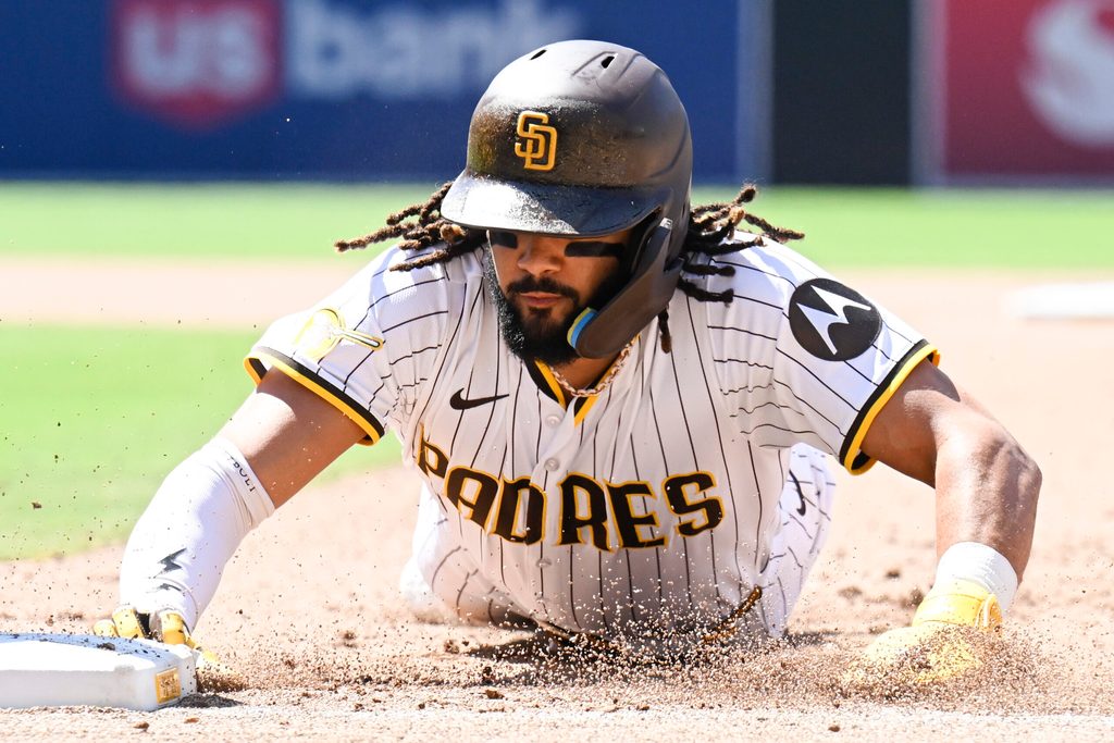 Jun 25, 2025; San Diego, California, USA; San Diego Padres right fielder Fernando Tatis Jr. (23) gets back to first base during the eighth inning against the Washington Nationals at Petco Park. Mandatory Credit: Denis Poroy-Imagn Images