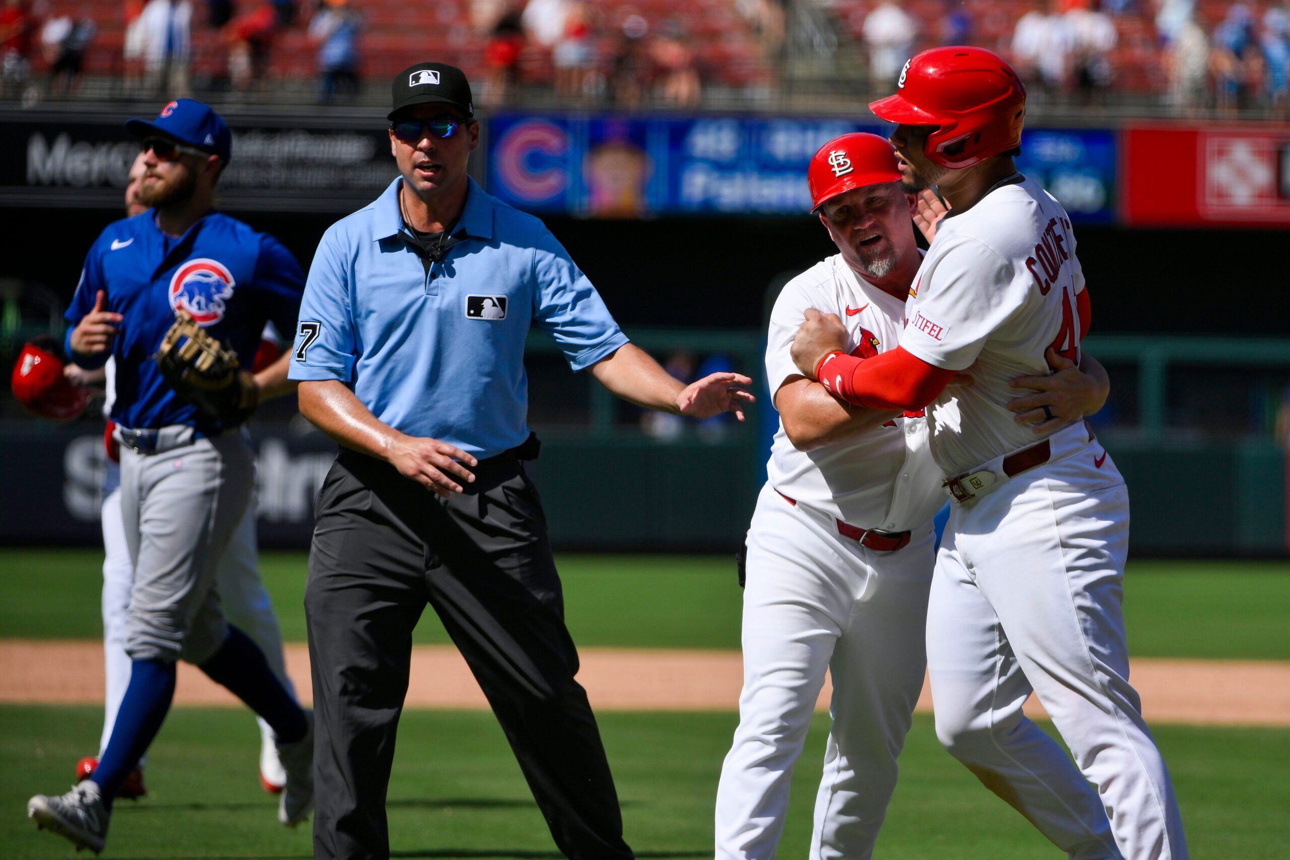 Jun 26, 2025; St. Louis, Missouri, USA; St. Louis Cardinals first baseman Willson Contreras (40) is held back by first base coach Stubby Clapp (82) as he exchanges words with Chicago Cubs relief pitcher Daniel Palencia (not pictured) after the Cubs defeated the Cardinals at Busch Stadium. Mandatory Credit: Jeff Curry-Imagn Images