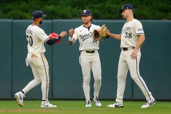 Jun 26, 2025; Minneapolis, Minnesota, USA; Minnesota Twins left fielder Willi Castro (50)  center fielder DaShawn Keirsey (21) and right fielder Matt Wallner (38) celebrate the win over the Seattle Mariners at Target Field. Mandatory Credit: Bruce Kluckhohn-Imagn Images