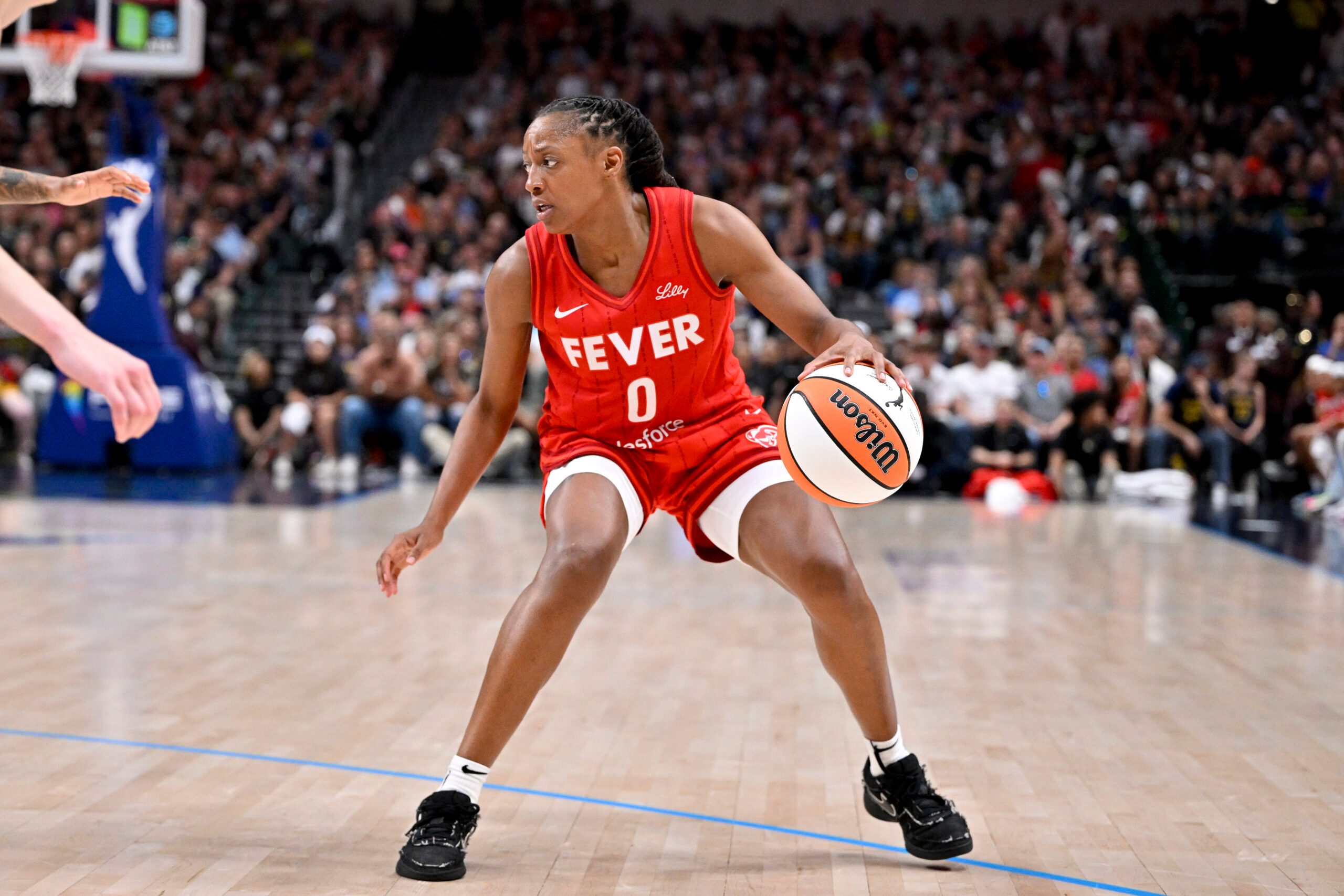 Jun 27, 2025; Dallas, Texas, USA; Indiana Fever guard Kelsey Mitchell (0) brings the ball up court against the Dallas Wings during the second half at the American Airlines Center. Mandatory Credit: Jerome Miron-Imagn Images