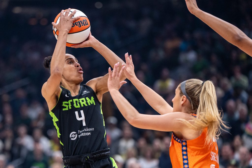 Jun 27, 2025; Seattle, Washington, USA; Seattle Storm guard Skylar Diggins (4) shoots the ball Connecticut Sun guard Jacy Sheldon (4) at Climate Pledge Arena. Mandatory Credit: Stephen Brashear-Imagn Images