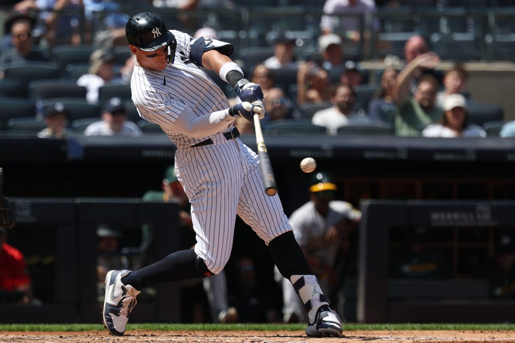 Jun 29, 2025; Bronx, New York, USA; New York Yankees designated hitter Aaron Judge (99) hits a two run home run during the fourth inning against the Athletics at Yankee Stadium. Mandatory Credit: Vincent Carchietta-Imagn Images