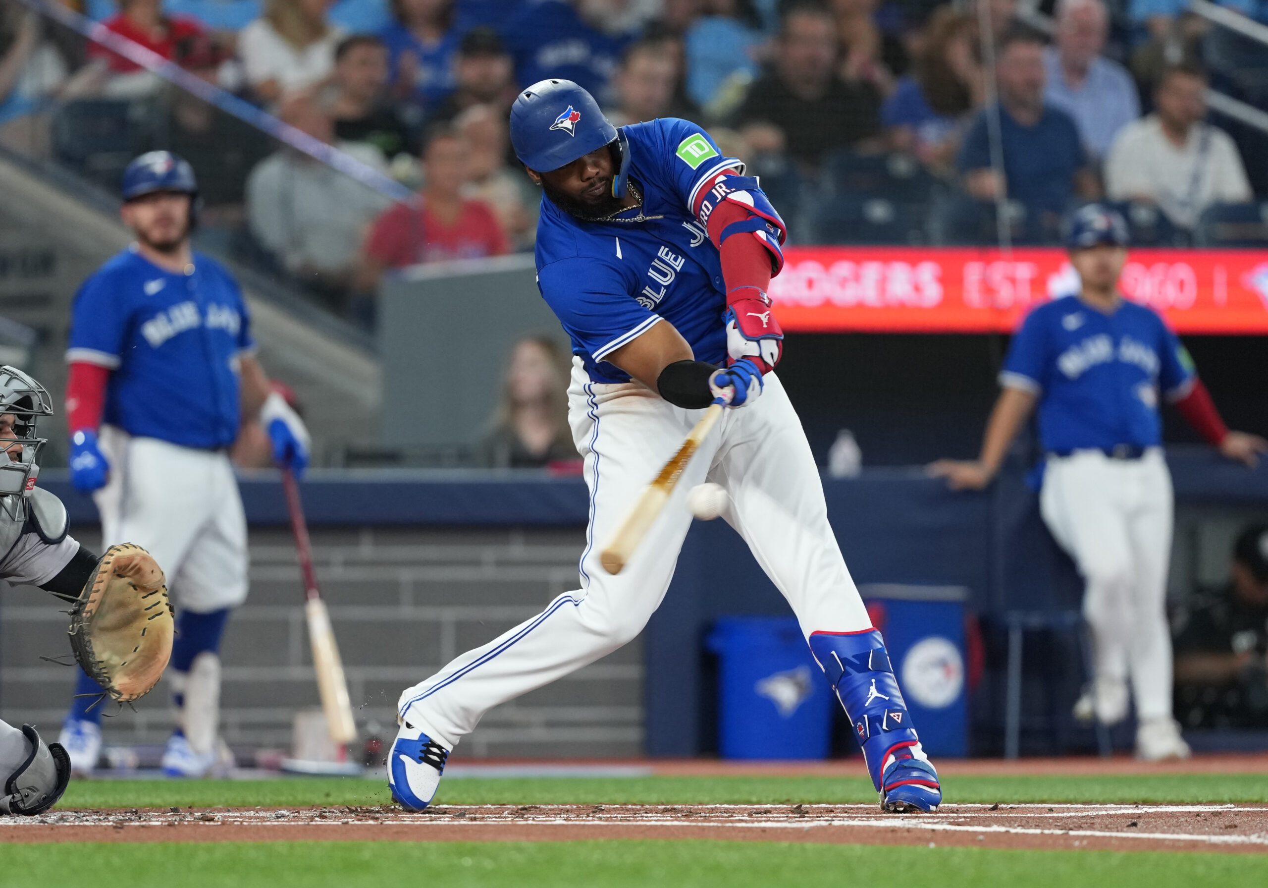 Jun 30, 2025; Toronto, Ontario, CAN; Toronto Blue Jays first base Vladimir Guerrero Jr. (27) hits a double against the New York Yankees during the first inning at Rogers Centre. Mandatory Credit: Nick Turchiaro-Imagn Images
