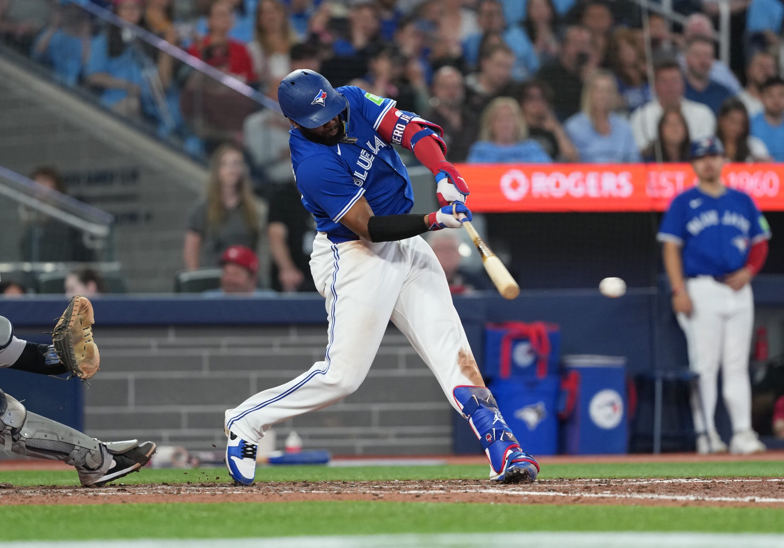 Jun 30, 2025; Toronto, Ontario, CAN; Toronto Blue Jays first baseman Vladimir Guerrero Jr. (27) hits a two-run double against the New York Yankees during the sixth inning at Rogers Centre. Mandatory Credit: Nick Turchiaro-Imagn Images