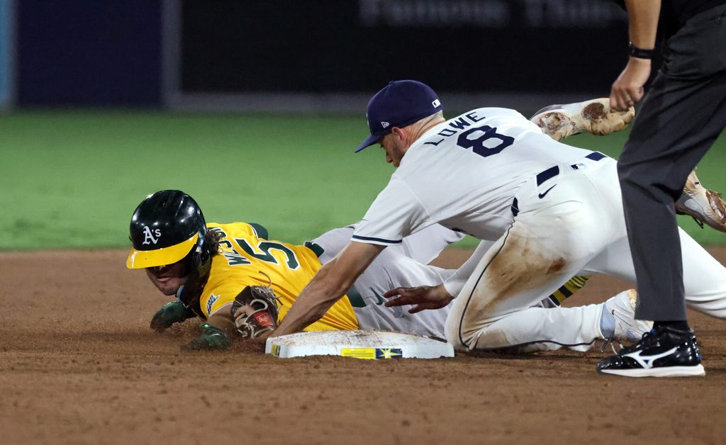 Jun 30, 2025; Tampa, Florida, USA; Tampa Bay Rays second base Brandon Lowe (8) tags out Athletics shortstop Jacob Wilson (5) during the ninth inning at George M. Steinbrenner Field. Mandatory Credit: Kim Klement Neitzel-Imagn Images