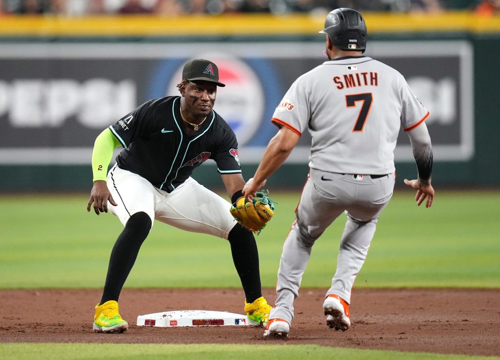 Arizona Diamondbacks infielder Geraldo Perdomo (2) tags out San Francisco Giants base runner Dominic Smith (7) at Chase Field on June 30, 2025.