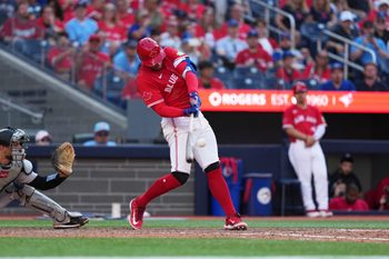 Jul 1, 2025; Toronto, Ontario, CAN; Toronto Blue Jays right fielder George Springer (4) hits a two run single against the New York Yankees during the eighth inning at Rogers Centre. Mandatory Credit: Nick Turchiaro-Imagn Images