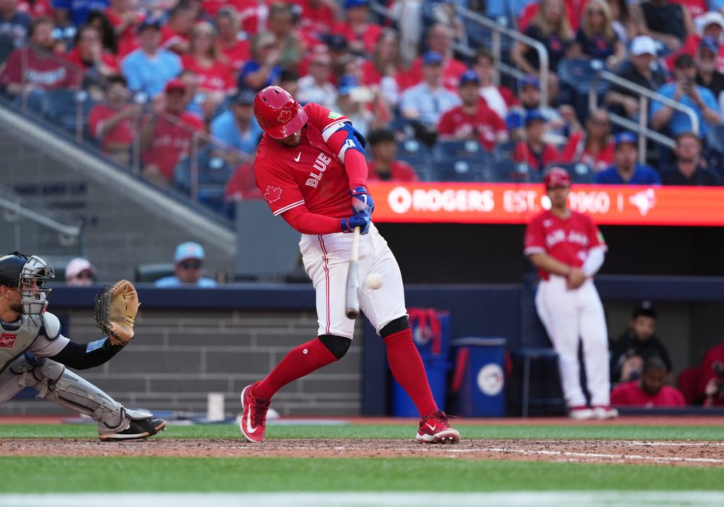 Jul 1, 2025; Toronto, Ontario, CAN; Toronto Blue Jays right fielder George Springer (4) hits a two run single against the New York Yankees during the eighth inning at Rogers Centre. Mandatory Credit: Nick Turchiaro-Imagn Images