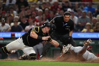 Jul 1, 2025; Pittsburgh, Pennsylvania, USA;  Pittsburgh Pirates catcher Henry Davis (32) tags St. Louis Cardinals designated hitter Jose Fermin (right) out at home plate attempting to score during the ninth inning at PNC Park. Mandatory Credit: Charles LeClaire-Imagn Images