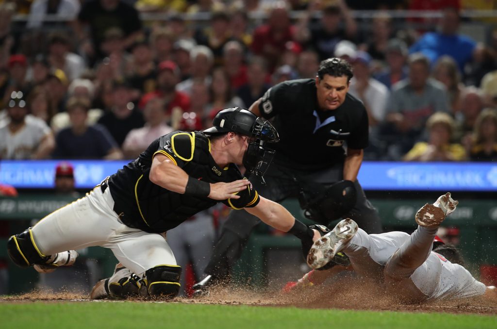 Jul 1, 2025; Pittsburgh, Pennsylvania, USA; Pittsburgh Pirates catcher Henry Davis (32) tags St. Louis Cardinals designated hitter Jose Fermin (right) out at home plate attempting to score during the ninth inning at PNC Park. Mandatory Credit: Charles LeClaire-Imagn Images