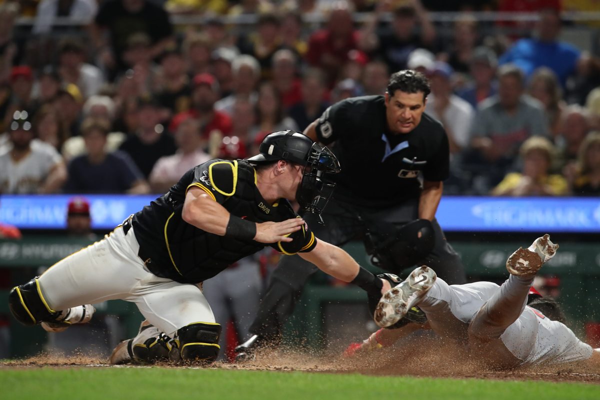Jul 1, 2025; Pittsburgh, Pennsylvania, USA; Pittsburgh Pirates catcher Henry Davis (32) tags St. Louis Cardinals designated hitter Jose Fermin (right) out at home plate attempting to score during the ninth inning at PNC Park. Mandatory Credit: Charles LeClaire-Imagn Images