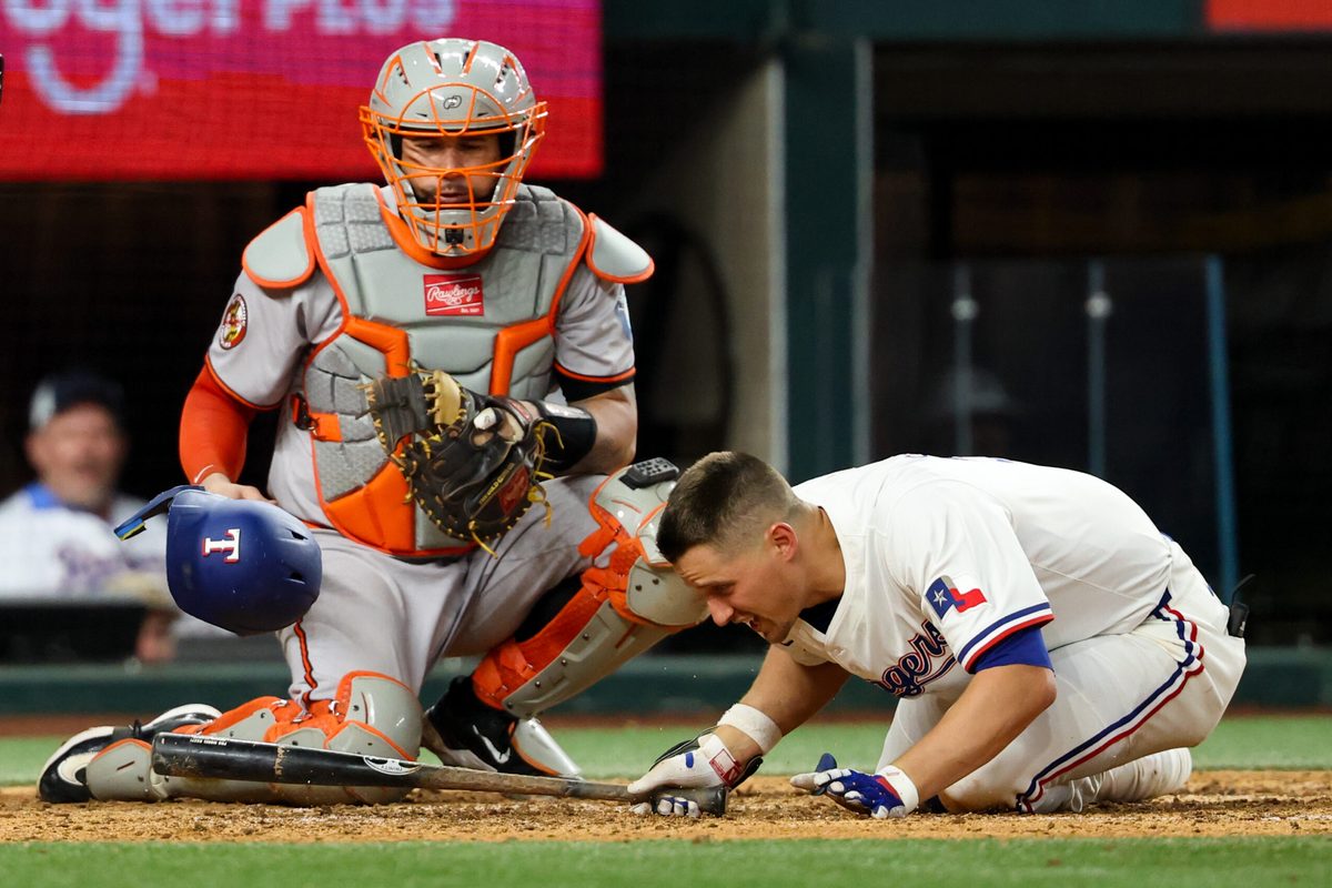 Jul 1, 2025; Arlington, Texas, USA; Texas Rangers shortstop Corey Seager (5) gets hit by a pitch during the eighth inning against the Baltimore Orioles at Globe Life Field. Mandatory Credit: Kevin Jairaj-Imagn Images