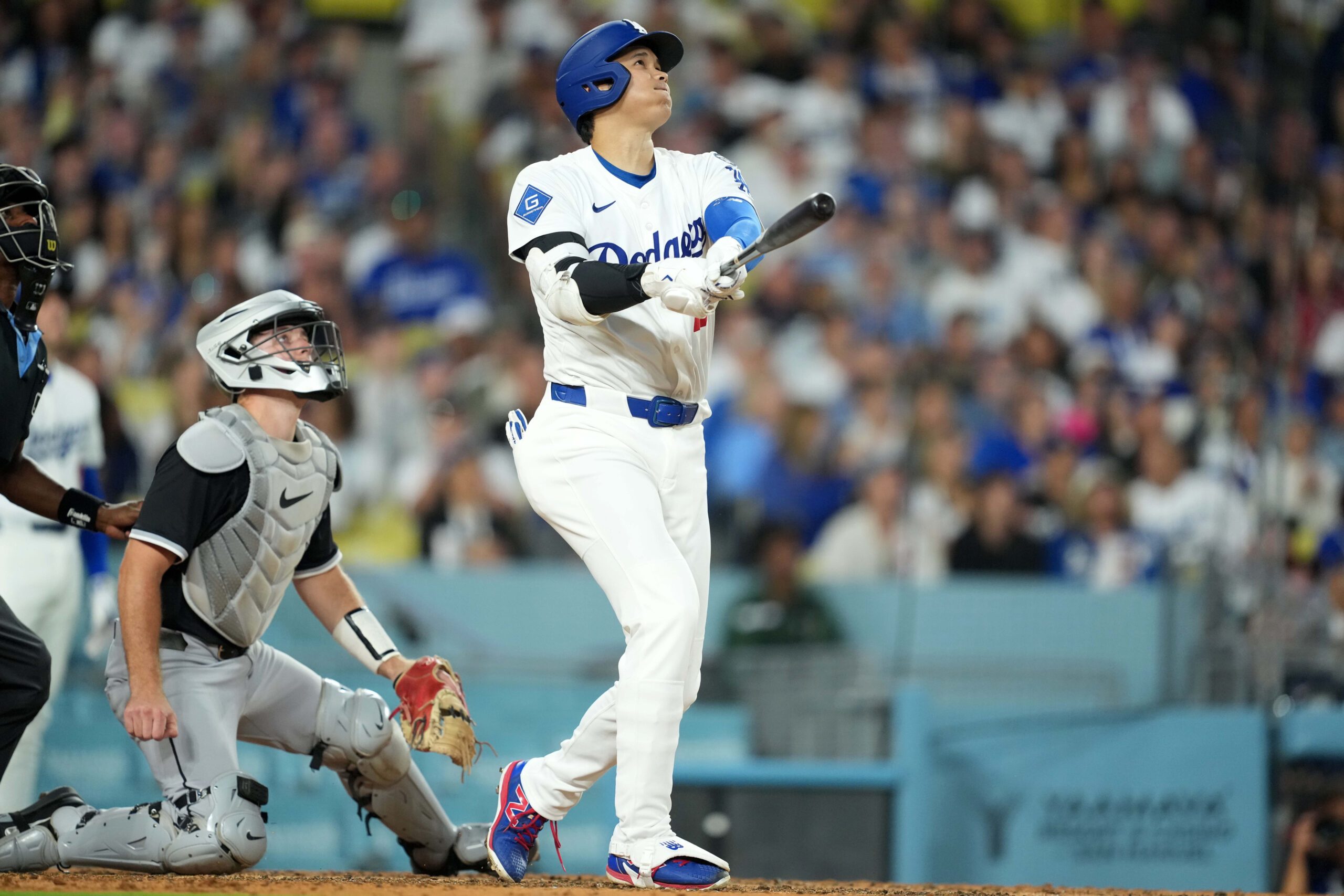 Jul 1, 2025; Los Angeles, California, USA; Los Angeles Dodgers designated hitter Shohei Ohtani (17) hits a home run ihe fourth inning as Chicago White Sox catcher Kyle Teel (8) watches at Dodger Stadium. Mandatory Credit: Kirby Lee-Imagn Images