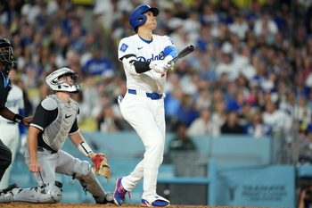 Jul 1, 2025; Los Angeles, California, USA; Los Angeles Dodgers designated hitter Shohei Ohtani (17) hits a home run ihe fourth inning as Chicago White Sox catcher Kyle Teel (8) watches at Dodger Stadium. Mandatory Credit: Kirby Lee-Imagn Images