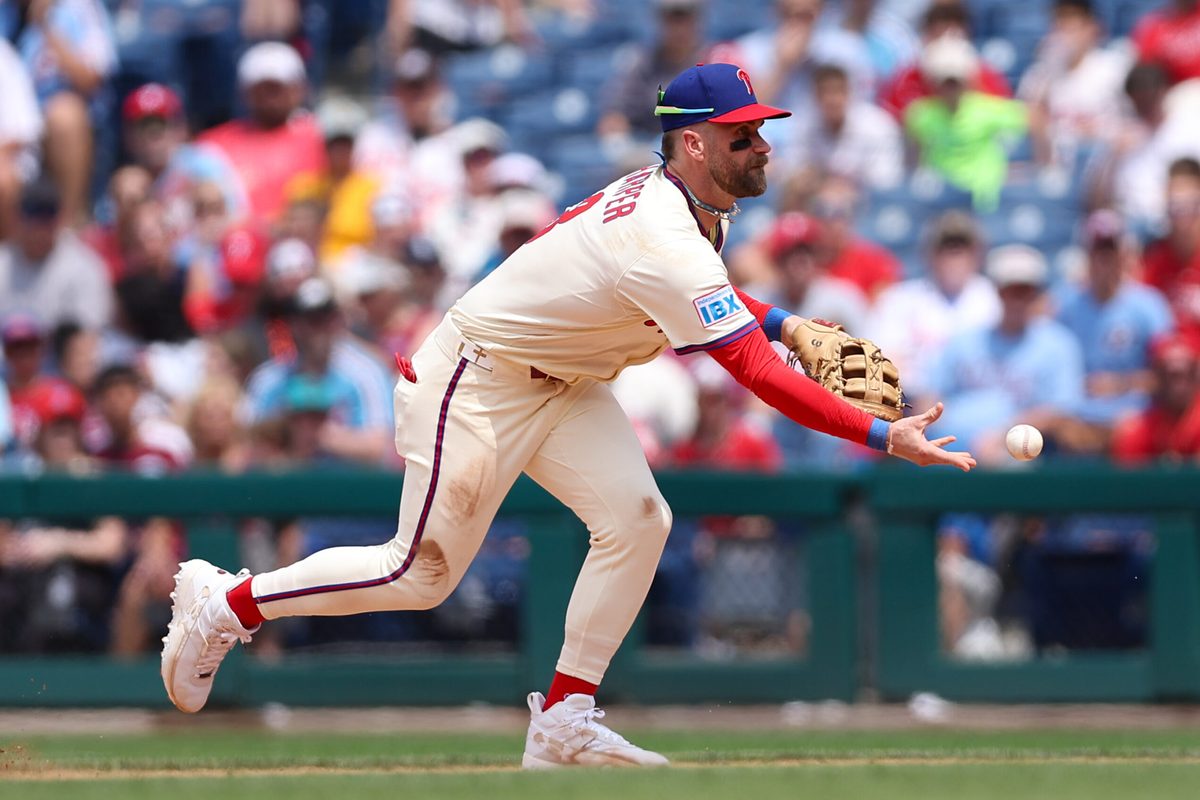 Jul 2, 2025; Philadelphia, Pennsylvania, USA; Philadelphia Phillies first base Bryce Harper (3) fields a ball for an out against the San Diego Padres during the fifth inning at Citizens Bank Park. Mandatory Credit: Bill Streicher-Imagn Images