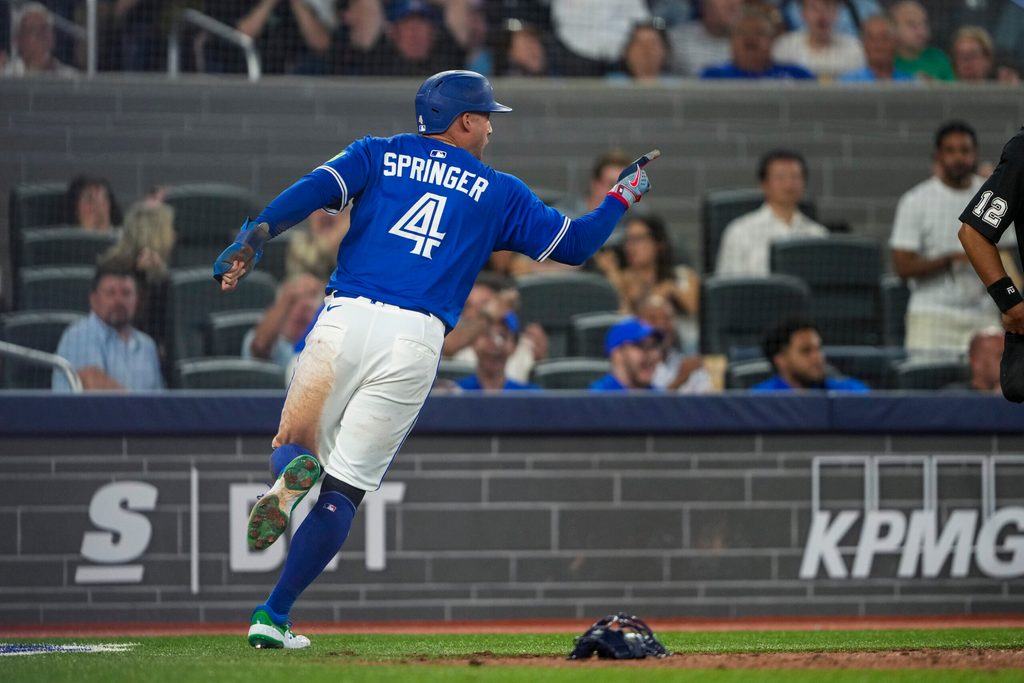 Jul 2, 2025; Toronto, Ontario, CAN; Toronto Blue Jays outfielder George Springer (4) celebrates after scoring against the New York Yankees during the eighth inning at Rogers Centre. Mandatory Credit: Kevin Sousa-Imagn Images