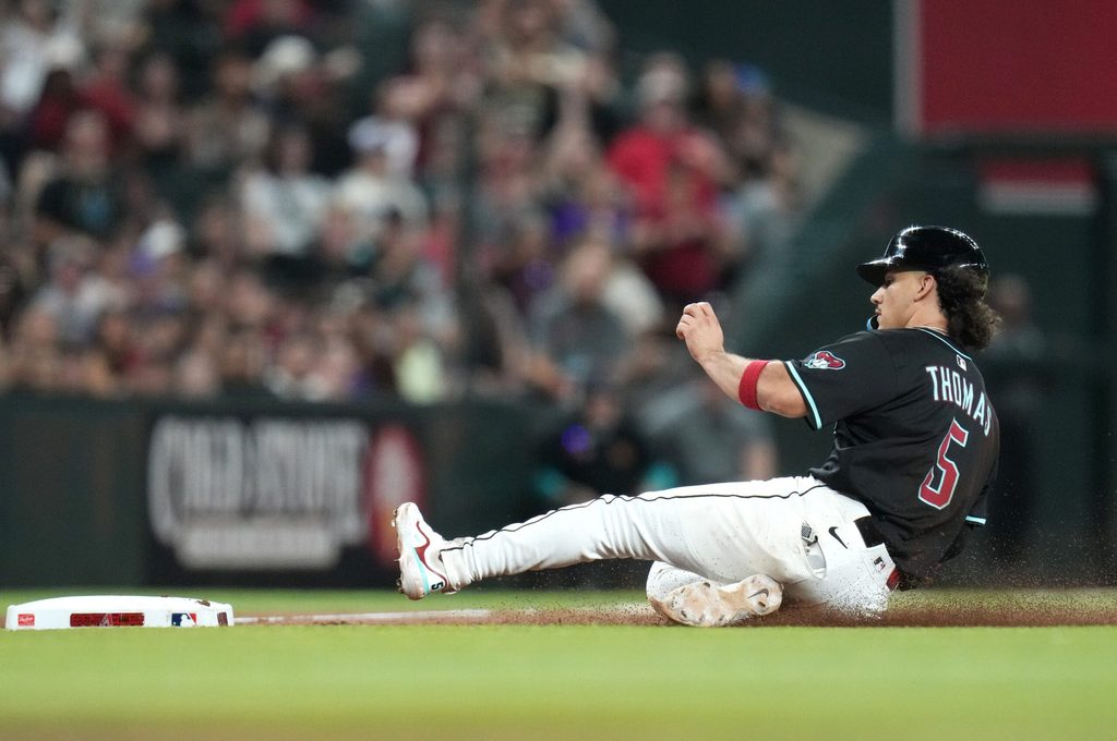 Arizona Diamondbacks base runner Alek Thomas (5) slides safely into third base against the San Francisco Giants at Chase Field on June 30, 2025.