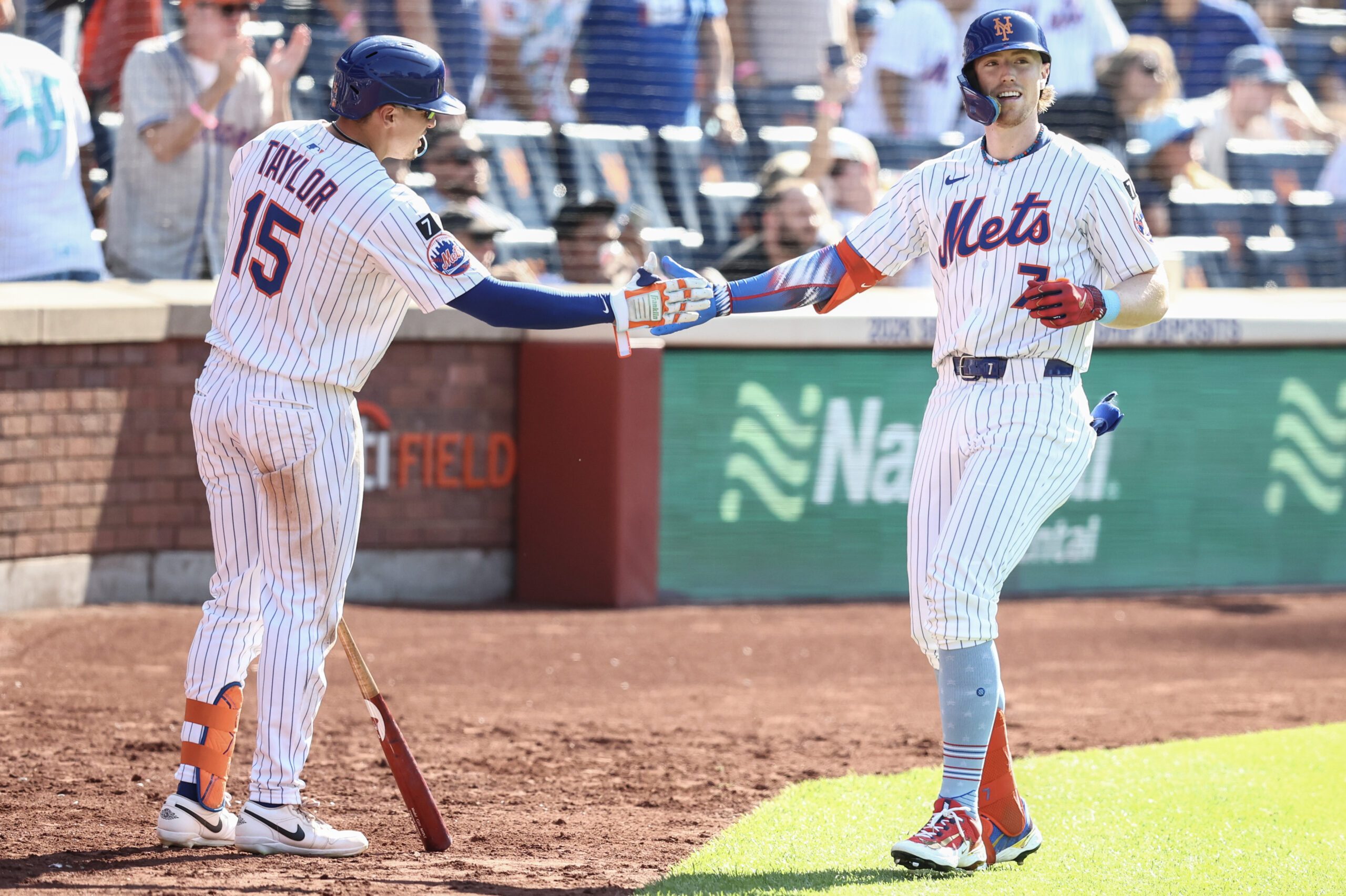 Jul 4, 2025; New York City, New York, USA; New York Mets third baseman Brett Baty (7) is greeted by center fielder Tyrone Taylor (15) after hitting a solo home run in the sixth inning against the New York Yankees at Citi Field. Mandatory Credit: Wendell Cruz-Imagn Images