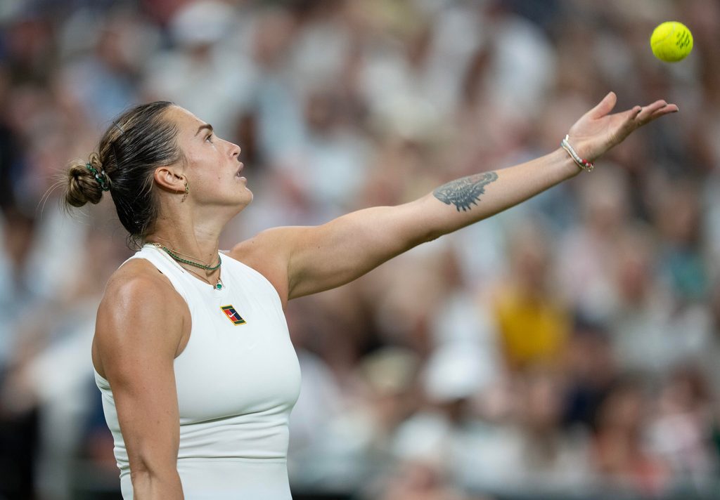 Jul 4, 2025; Wimbledon, United Kingdom; Aryna Sabalenka tosses the ball to serve during her match against Emma Raducanu of Great Britain on day five at the All England Lawn Tennis and Croquet Club. Mandatory Credit: Susan Mullane-Imagn Images