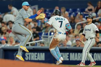Jul 4, 2025; Miami, Florida, USA; Miami Marlins right fielder Jesus Sanchez (7) reaches first base on a throwing error by   Milwaukee Brewers starting pitcher Quinn Priester (not pictured) during the third inning at loanDepot Park. Mandatory Credit: Sam Navarro-Imagn Images