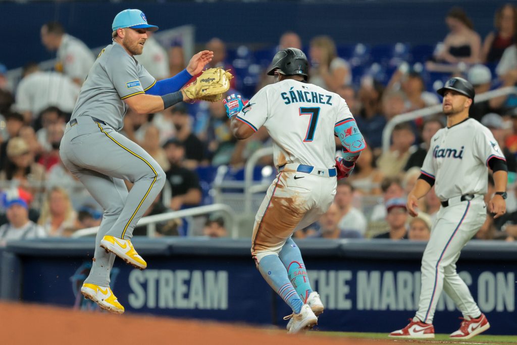 Jul 4, 2025; Miami, Florida, USA; Miami Marlins right fielder Jesus Sanchez (7) reaches first base on a throwing error by Milwaukee Brewers starting pitcher Quinn Priester (not pictured) during the third inning at loanDepot Park. Mandatory Credit: Sam Navarro-Imagn Images
