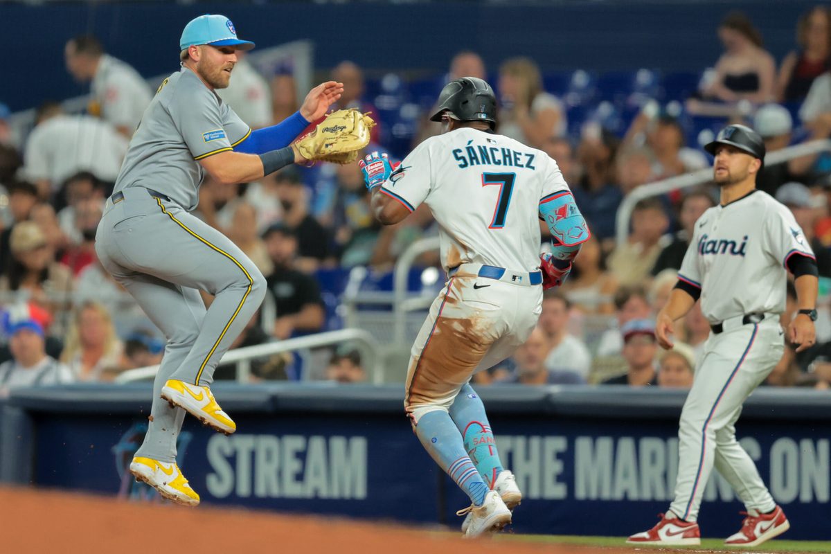 Jul 4, 2025; Miami, Florida, USA; Miami Marlins right fielder Jesus Sanchez (7) reaches first base on a throwing error by Milwaukee Brewers starting pitcher Quinn Priester (not pictured) during the third inning at loanDepot Park. Mandatory Credit: Sam Navarro-Imagn Images