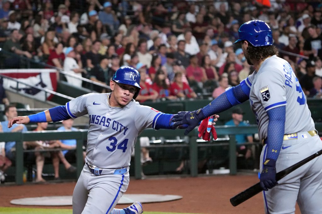Jul 4, 2025; Phoenix, Arizona, USA; Kansas City Royals catcher Freddy Fermin (34) slaps hands with Kansas City Royals first base Vinnie Pasquantino (9) after scoring a run against the Arizona Diamondbacks during the second inning at Chase Field. Mandatory Credit: Joe Camporeale-Imagn Images