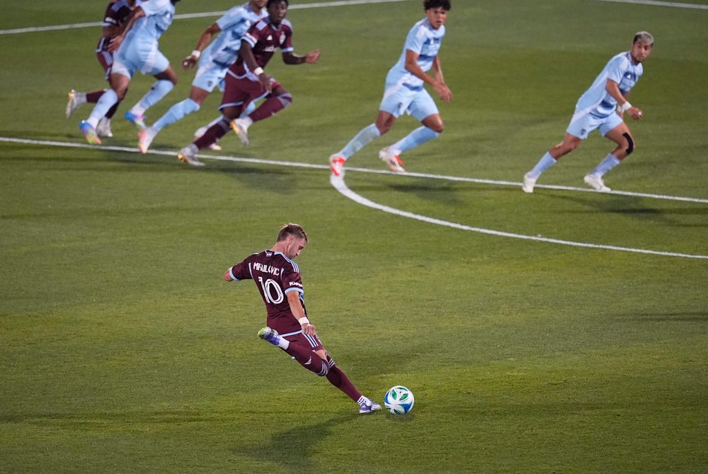 Jul 4, 2025; Commerce City, Colorado, USA; Colorado Rapids midfielder Djordje Mihailovic (10) kicks the ball in the second half against Sporting Kansas City at Dick's Sporting Goods Park. Mandatory Credit: Ron Chenoy-Imagn Images
