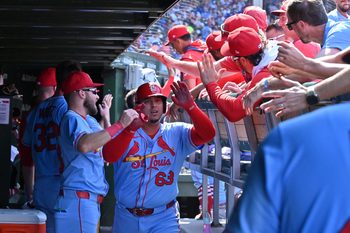 Jul 5, 2025; Chicago, Illinois, USA; St. Louis Cardinals pinch hitter Yohel Pozo (63) celebrates with teammates in the dugout after hitting a three-run home run during the eighth inning against the Chicago Cubs at Wrigley Field. Mandatory Credit: Patrick Gorski-Imagn Images