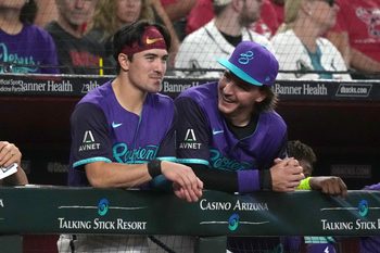 Jul 5, 2025; Phoenix, Arizona, USA; Arizona Diamondbacks outfielder Corbin Carroll (7) and  pitcher Brandon Pfaadt (32) talk against the Kansas City Royals in the first inning at Chase Field. Mandatory Credit: Rick Scuteri-Imagn Images