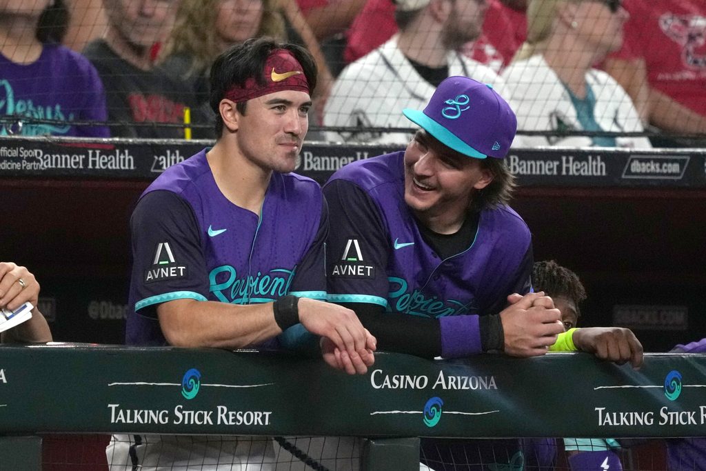 Jul 5, 2025; Phoenix, Arizona, USA; Arizona Diamondbacks outfielder Corbin Carroll (7) and pitcher Brandon Pfaadt (32) talk against the Kansas City Royals in the first inning at Chase Field. Mandatory Credit: Rick Scuteri-Imagn Images