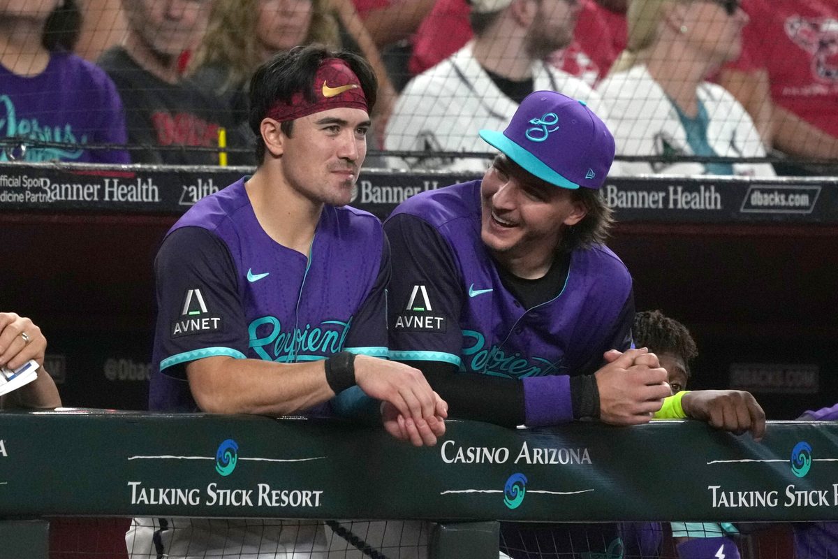 Jul 5, 2025; Phoenix, Arizona, USA; Arizona Diamondbacks outfielder Corbin Carroll (7) and pitcher Brandon Pfaadt (32) talk against the Kansas City Royals in the first inning at Chase Field. Mandatory Credit: Rick Scuteri-Imagn Images