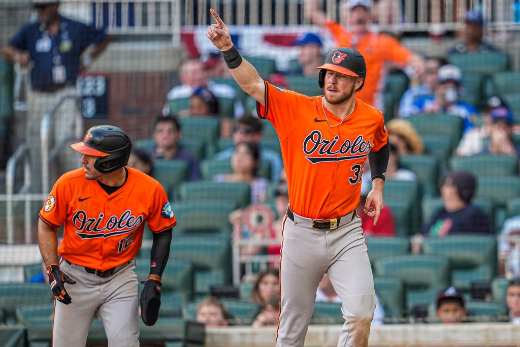 Jul 5, 2025; Cumberland, Georgia, USA; Baltimore Orioles first baseman Ryan O'Hearn (32) and right fielder Ramon Laureano (rear left) react after scoring against the Atlanta Braves during the tenth inning at Truist Park. Mandatory Credit: Dale Zanine-Imagn Images