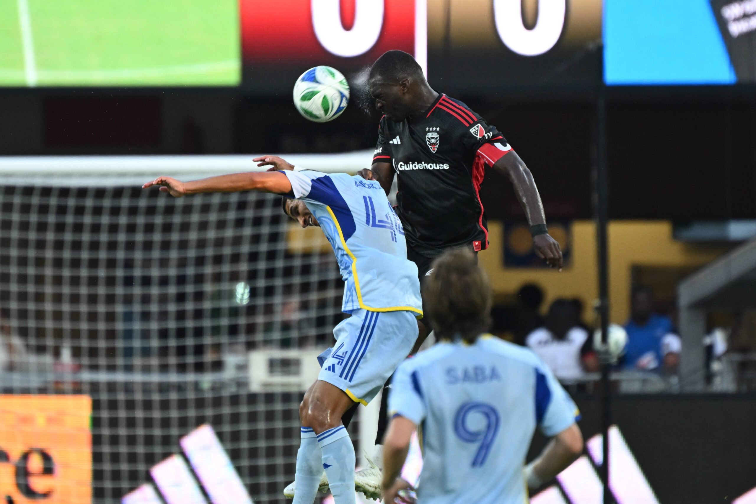 Jul 5, 2025; Washington, District of Columbia, USA; D.C. United forward Christian Benteke (20) battles Atlanta United defender Luis Abram (44) for the ball during the first half at Audi Field. Mandatory Credit: Rafael Suanes-Imagn Images