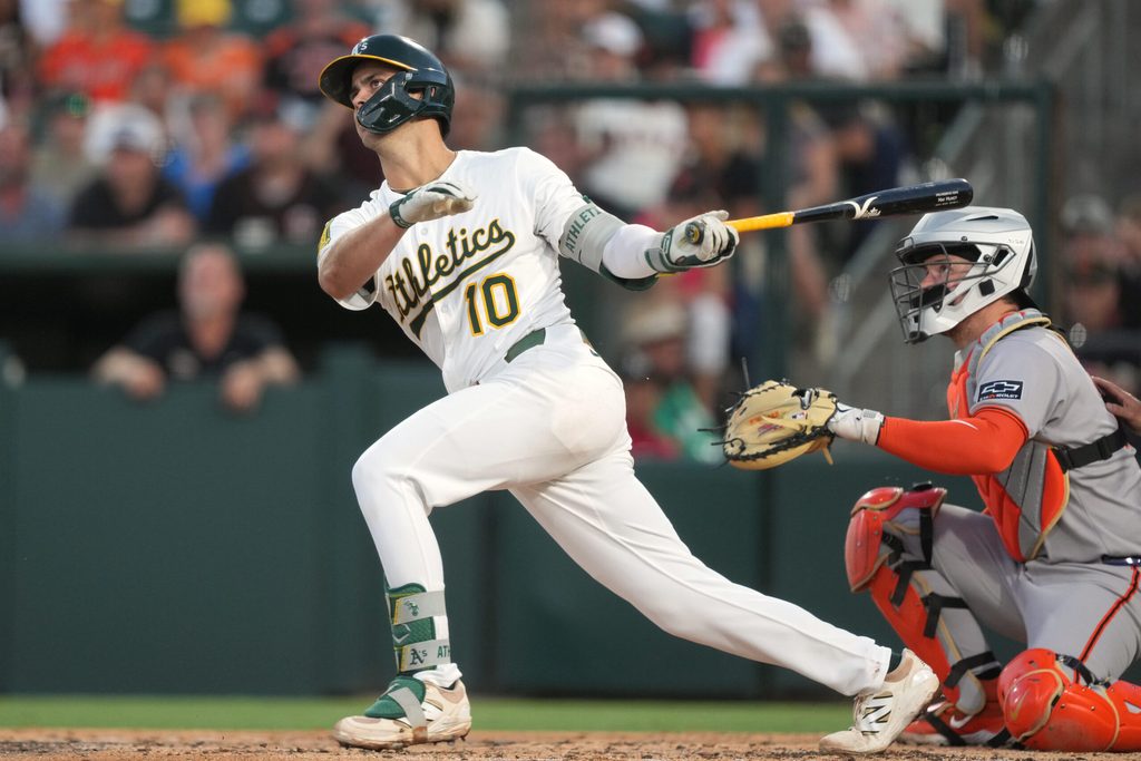 Jul 5, 2025; West Sacramento, California, USA; Athletics third baseman Max Muncy (10) hits a double against the San Francisco Giants during the fifth inning at Sutter Health Park. Mandatory Credit: Darren Yamashita-Imagn Images
