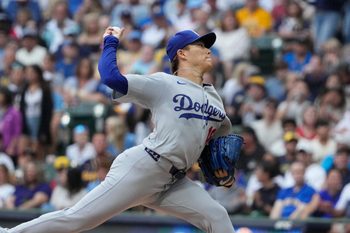 Jul 7, 2025; Milwaukee, Wisconsin, USA; Los Angeles Dodgers pitcher Yoshinobu Yamamoto (18) delivers a pitch against the Milwaukee Brewers in the first inning at American Family Field. Mandatory Credit: Michael McLoone-Imagn Image