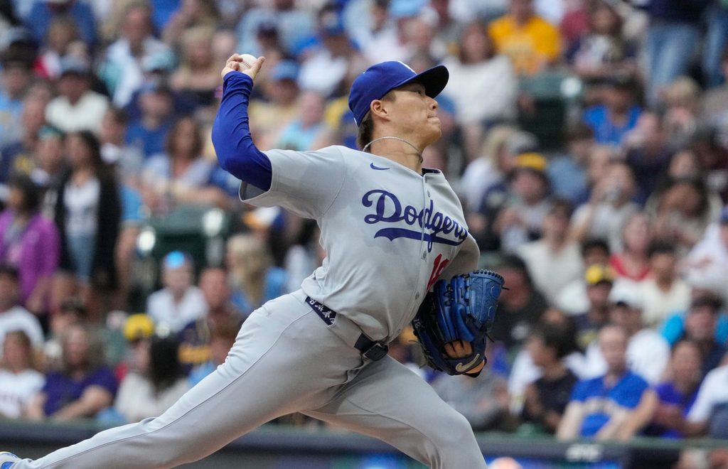 Jul 7, 2025; Milwaukee, Wisconsin, USA; Los Angeles Dodgers pitcher Yoshinobu Yamamoto (18) delivers a pitch against the Milwaukee Brewers in the first inning at American Family Field. Mandatory Credit: Michael McLoone-Imagn Image
