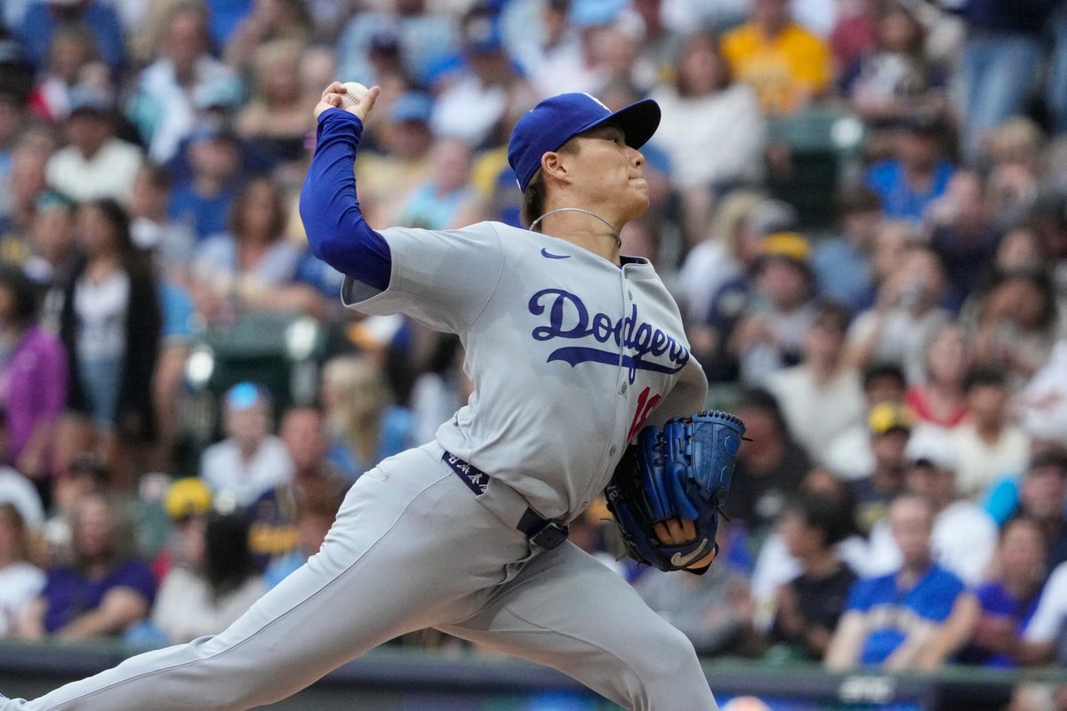 Jul 7, 2025; Milwaukee, Wisconsin, USA; Los Angeles Dodgers pitcher Yoshinobu Yamamoto (18) delivers a pitch against the Milwaukee Brewers in the first inning at American Family Field. Mandatory Credit: Michael McLoone-Imagn Image