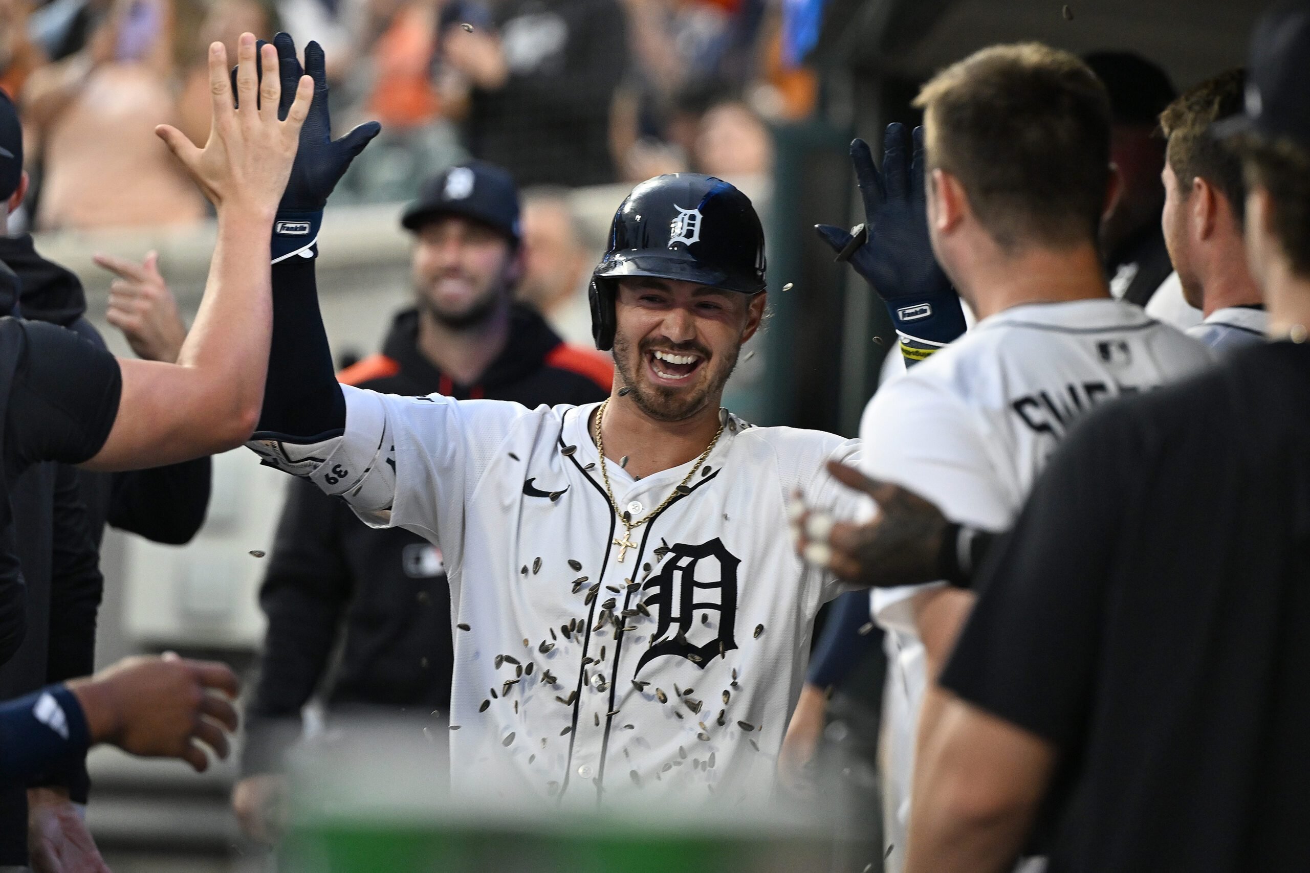 Jul 7, 2025; Detroit, Michigan, USA; Detroit Tigers right fielder Zach McKinstry (39) gets showered with sunflower seeds as he celebrates in the dugout after hitting a home run against the Tampa Bay Rays in the seventh inning at Comerica Park. Mandatory Credit: Lon Horwedel-Imagn Images