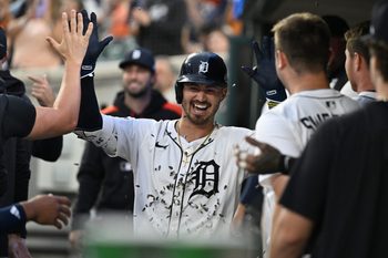 Jul 7, 2025; Detroit, Michigan, USA; Detroit Tigers right fielder Zach McKinstry (39) gets showered with sunflower seeds as he celebrates in the dugout after hitting a home run against the Tampa Bay Rays in the seventh inning at Comerica Park. Mandatory Credit: Lon Horwedel-Imagn Images